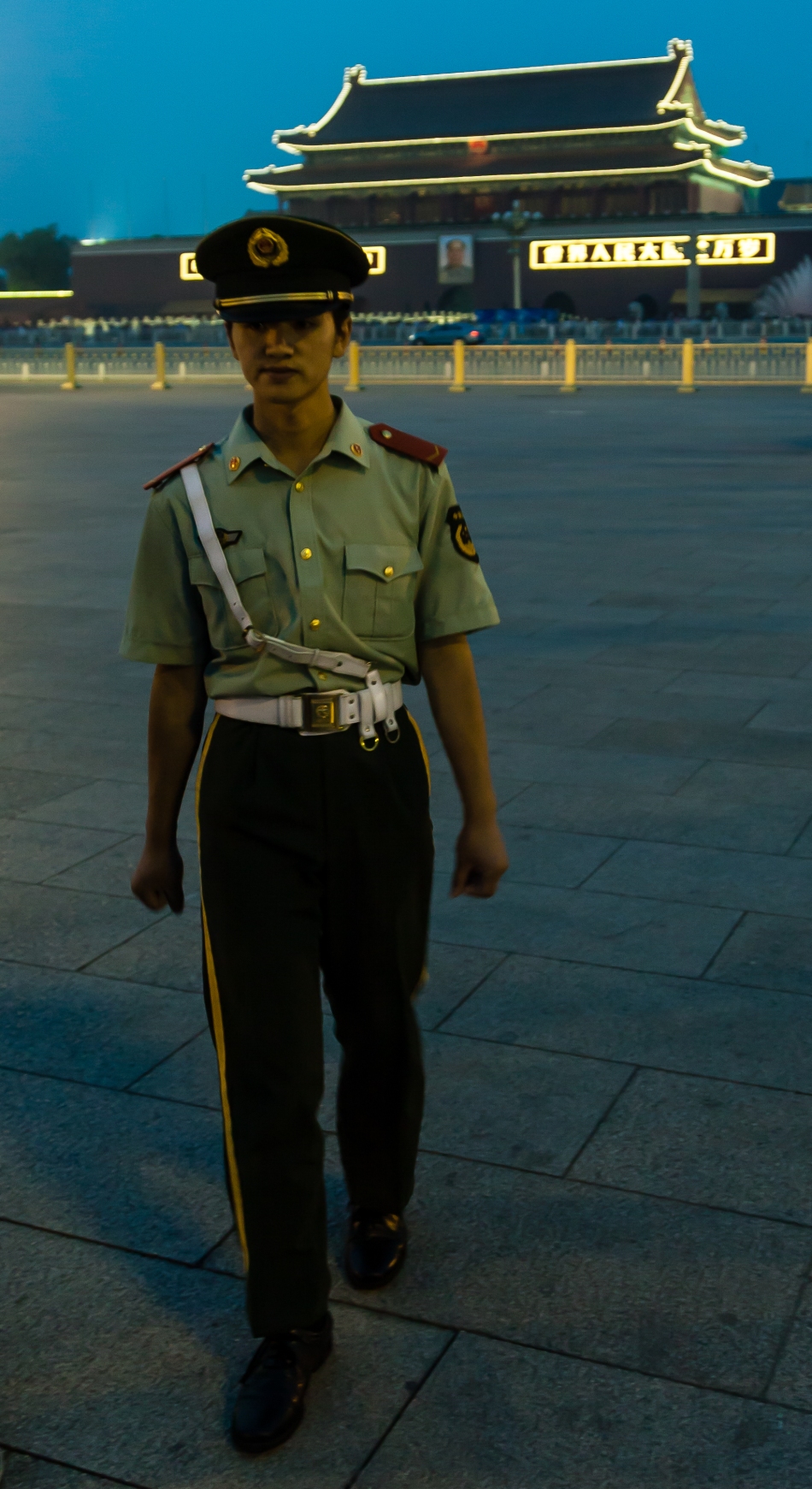 A police officer clearing the Tiananmen square in the evening.